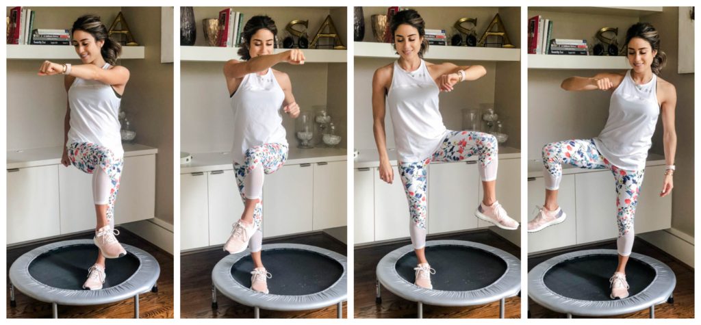 fitness blogger using a small rebounder/mini trampoline in floral printed workout leggings from Fabletics and a white tank sharing a workout at home | adoubledose.com