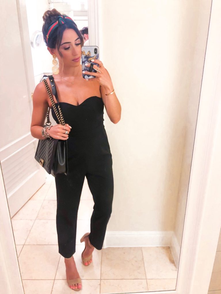 fashion blogger wearing a black strapless jumpsuit and a headband from amazon