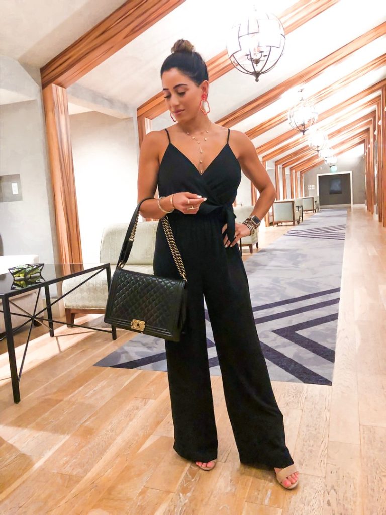 fashion blogger wearing a black jumpsuit from express great for petites 