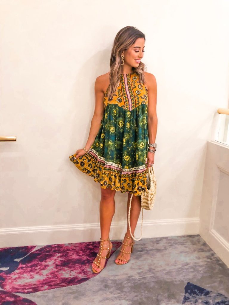 fashion blogger wearing green and yellow free people flowdy dress and rockstud caged heels
