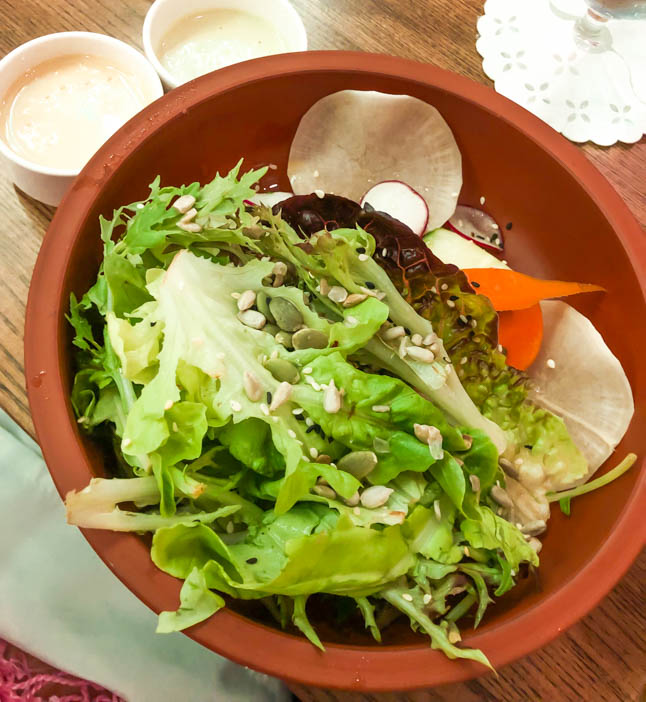 green salad at Agua restaurant in grand cayman island with tahini dressing