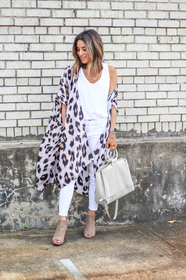 fashion blogger wearing leopard kimono with white jeans and peep toe booties and a white summer bag