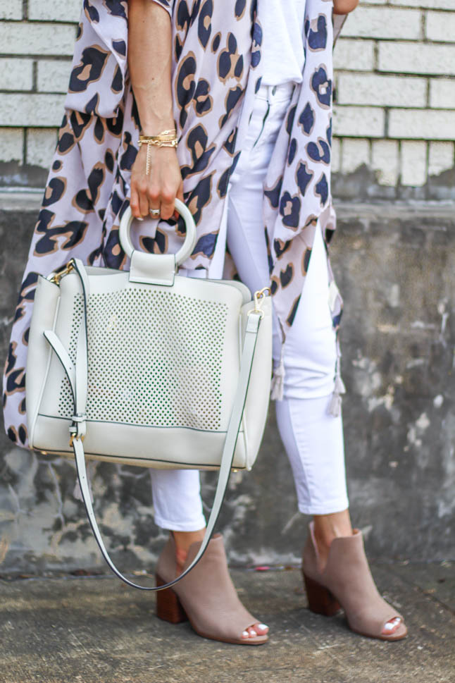 fashion blogger wearing leopard kimono with white jeans and peep toe booties and a white summer bag