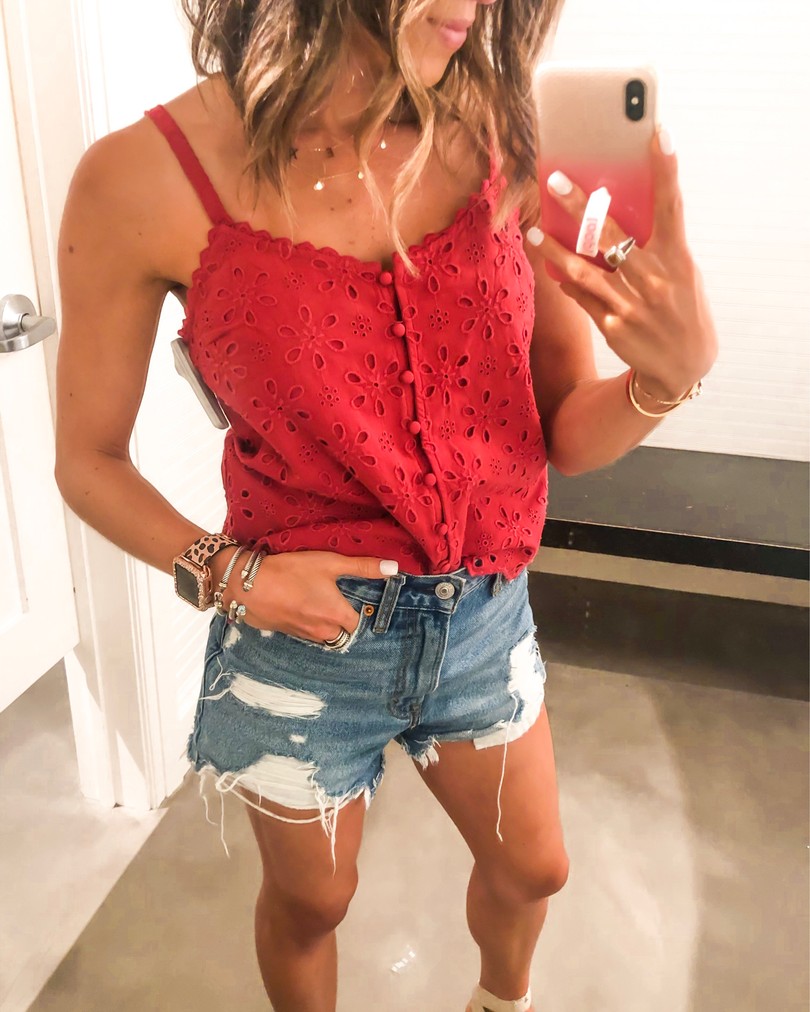 fashion blogger wearing red eyelet camisole and ripped denim shorts from abercrombie for summer style and july 4th