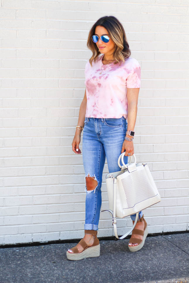 Fashion Blogger wearing ripped levis jeans with a tie dye cropped top and neutral wedges | adoubledose.com