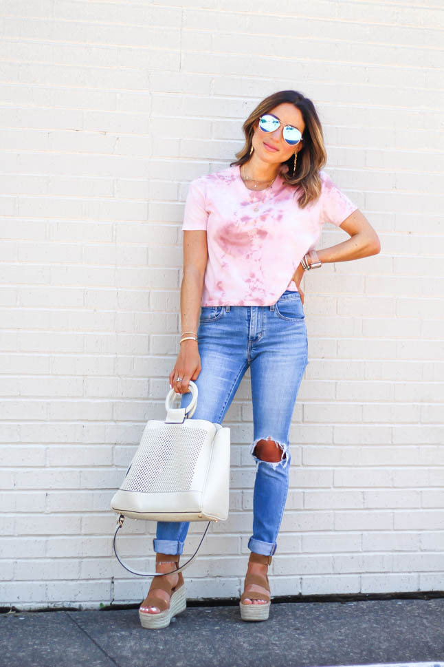 Fashion Blogger wearing ripped levis jeans with a tie dye cropped top and neutral wedges | adoubledose.com