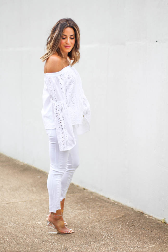 lifestyle and fashion blogger alexis belbel shares an all white look from express: a white off shoulder eyelet top with bell sleeves and some skinny white ankle jeans with clear wedge sandals
