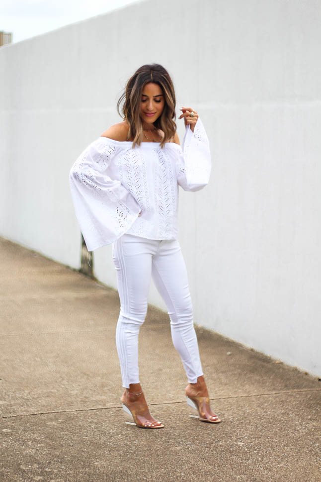 lifestyle and fashion blogger alexis belbel shares an all white look from express: a white off shoulder eyelet top with bell sleeves and some skinny white ankle jeans with clear wedge sandals 