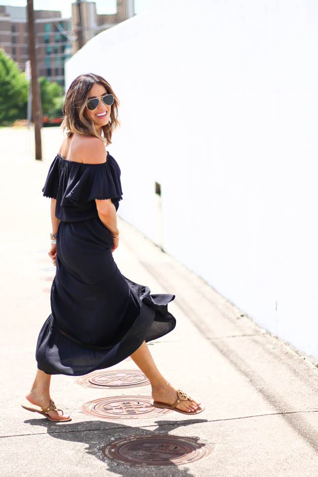 fashion and lifestyle blogger alexis belbel of a double dose wearing an off shoulder black maxi dress with tory burch miller sandals 