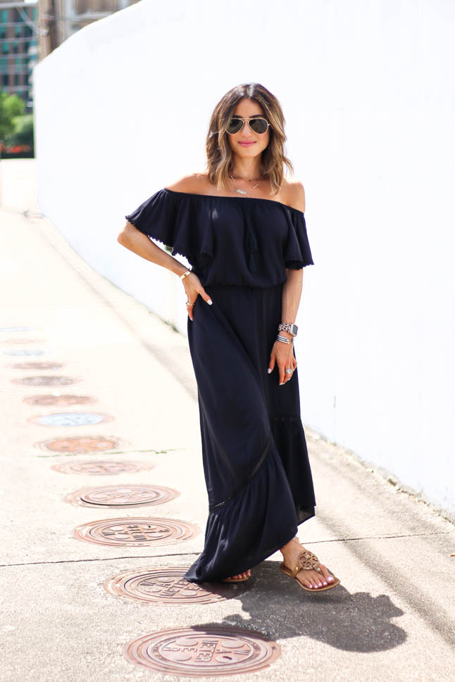fashion and lifestyle blogger alexis belbel of a double dose wearing an off shoulder black maxi dress with tory burch miller sandals 
