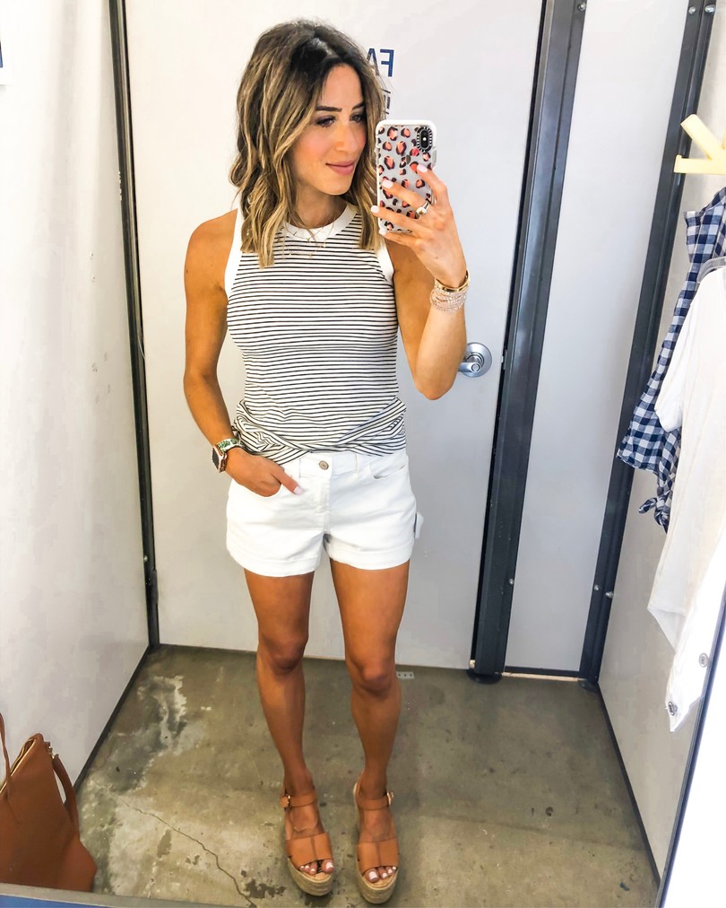 fashion blogger wearing navy and white striped tank top and white shorts from old navy on sale for july 4th