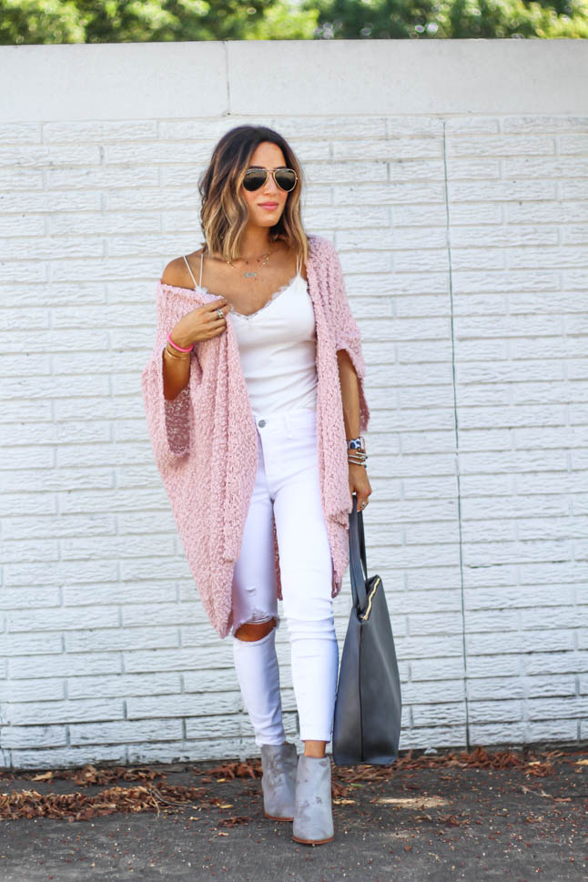 fashion and lifestyle blogger alexis belbel of a double dose wearing white ripped jeans for petites from abercrombie, a white lace cami from express, a pink wrap sweater from sole society and a grey tote bad and grey booties from sole society.
