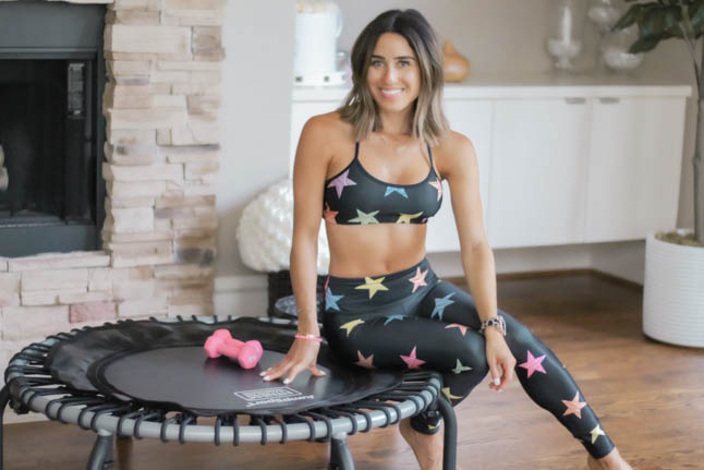 lifestyle and fashion blogger alexis belbel of a double dose shares her rebounder workout and the benefits of doing a rebounder workout with a Jumpsport trampoline. Wearing a star print workout legging set from Goldsheep.