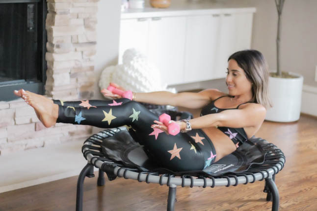 lifestyle and fashion blogger alexis belbel of a double dose shares her rebounder workout and the benefits of doing a rebounder workout with a Jumpsport trampoline. Wearing a star print workout legging set from Goldsheep.