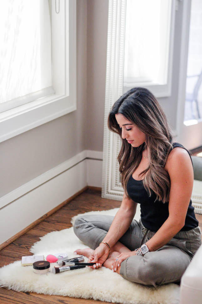fashion and lifestyle blogger samantha belbel of a double dose wearing some olive linen joggers and a black tank sharing her must haves for a flawless face using Charlotte Tilbury concealer and genius magic powder from Nordstrom