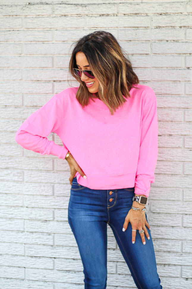 fashion and lifestyle blogger alexis belbel of adouble dose wearing a neon pink cropped sweatshirt with skinny stretchy jeans and epsadrille wedges from walmart fashion we dress america