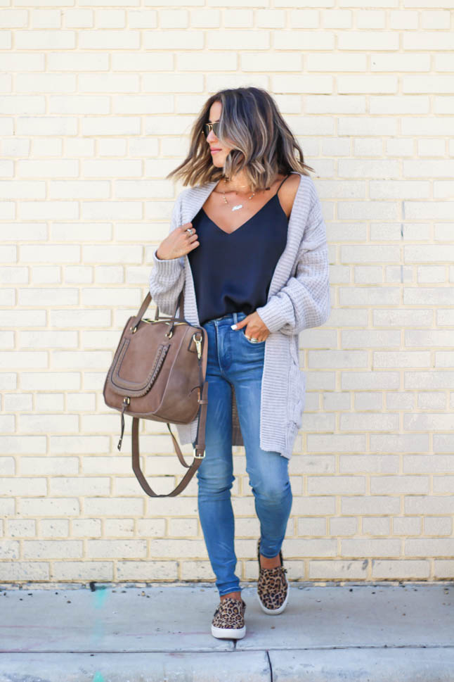 lifestyle and fashion blogger, alexis belbel, of A Double Dose, wearing stretchy jeans for petites from express with a cable knit cardigan and a silk camisole with Dr. Scholl's leopard slip on sneakers from shoes.com