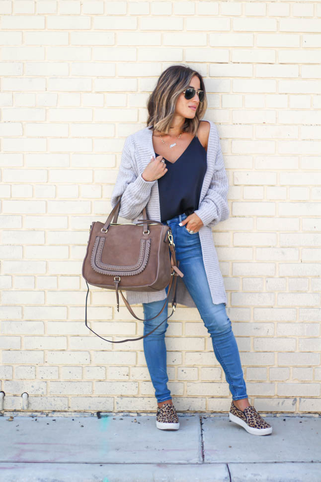 lifestyle and fashion blogger alexis belbel wearing a head to toe look from express. Cable knit taupe cardigan, black silk cami, high rise stretchy skinny jeans and leopard slip on sneakers