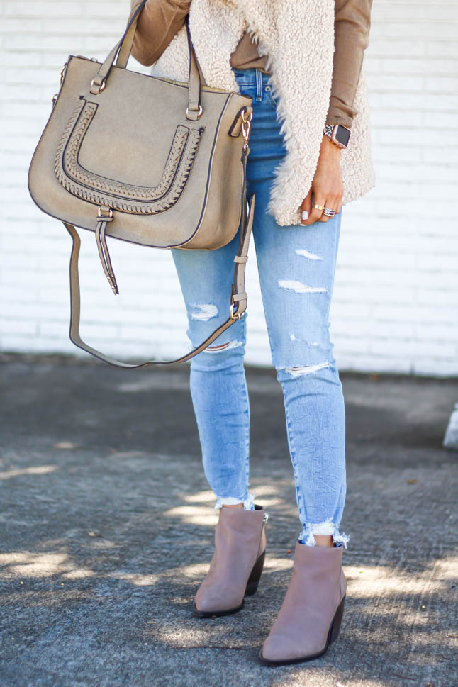 lifestyle and fashion blogger alexis belbel wearing a neutral sherpa vest from sole society with a tan long sleeve shirt and ripped jeans from abercrombie with a taupe satchel bag and pointed booties from sole society | adoubledose.com