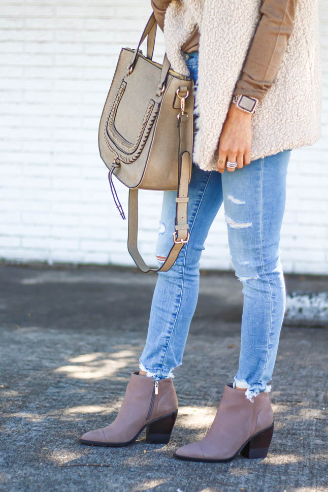 lifestyle and fashion blogger alexis belbel wearing a neutral sherpa vest from sole society with a tan long sleeve shirt and ripped jeans from abercrombie with a taupe satchel bag and pointed booties from sole society | adoubledose.com