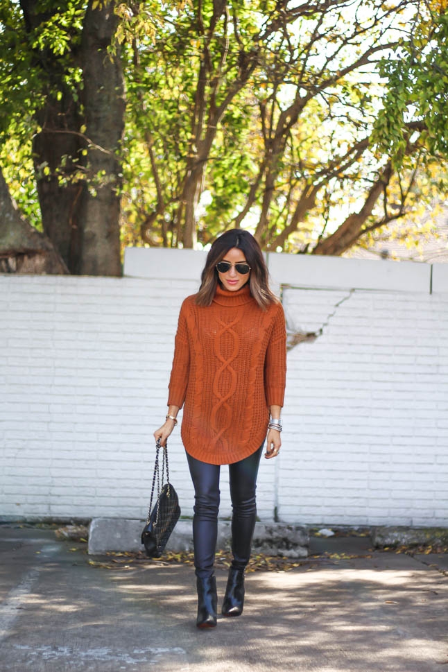 lifestyle and fashion blogger alexis belbel wearing a cable knit tunic sweater with black faux leather leggings from express for thanksgiving outfit ideas  | adoubledose.com