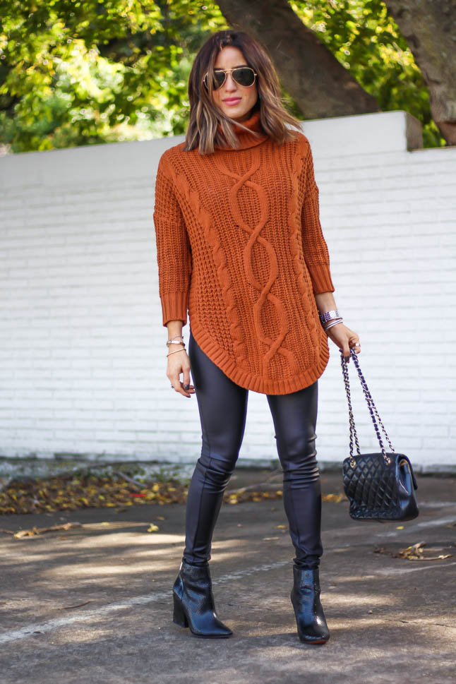 lifestyle and fashion blogger alexis belbel wearing a cable knit tunic sweater with black faux leather leggings from express for thanksgiving outfit ideas  | adoubledose.com