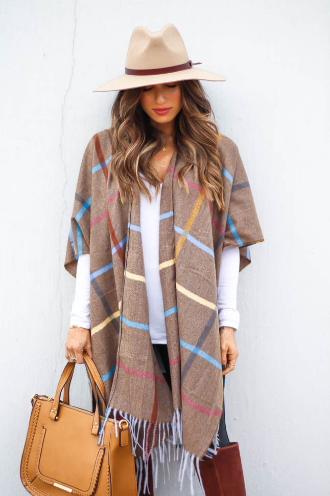 lifestyle and fashion blogger samantha belbel wearing plaid windowpane poncho cape from sole society with a tan hat, black faux leather spanx leggings, tan satchel bag and suede boots from sole society | adoubledose.com