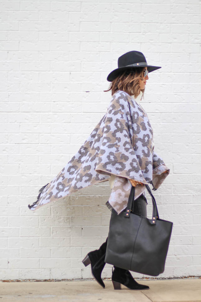 lifestyle and fashion blogger alexis belbel wearing a leopard poncho cape with an ivory free people sweater tunic, black hat and black suede boots from sole society  | adoubledose.com