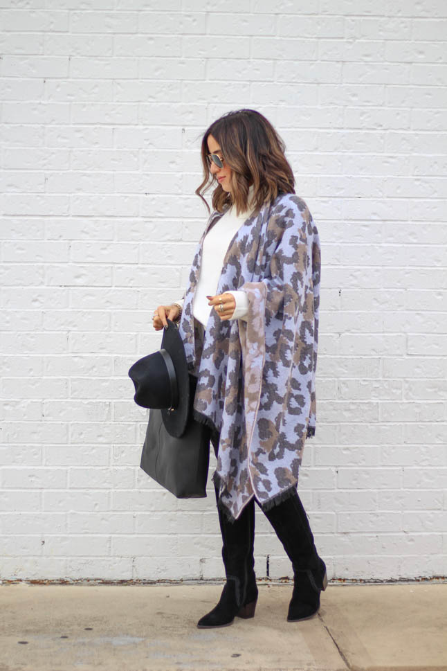 lifestyle and fashion blogger alexis belbel wearing a leopard poncho cape with an ivory free people sweater tunic, black hat and black suede boots from sole society  | adoubledose.com