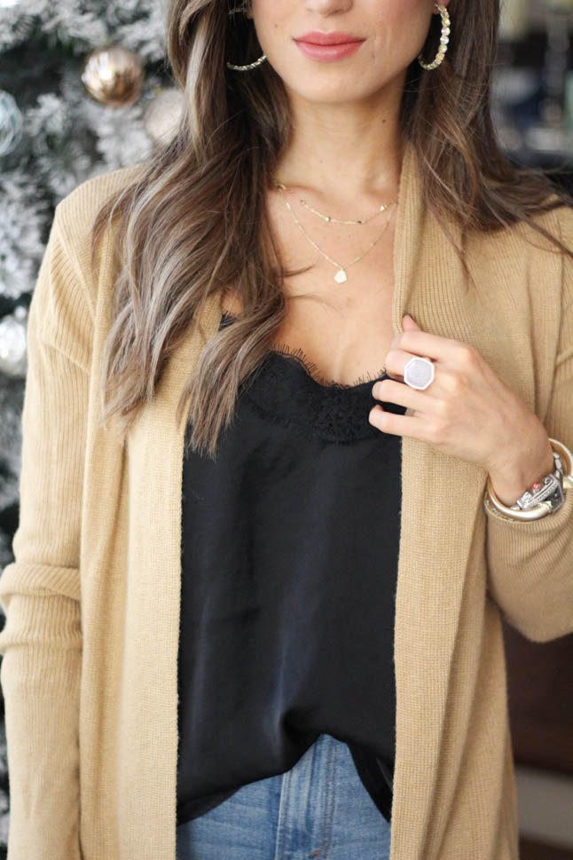 lifestyle and fashion blogger samantha belbel wearing kendra scott hoop earrings, kendra scott layered necklace, kendra scott cocktail ring and cuff bracelet for the holidays with a camel colored cardigan and black lace cami  | adoubledose.com