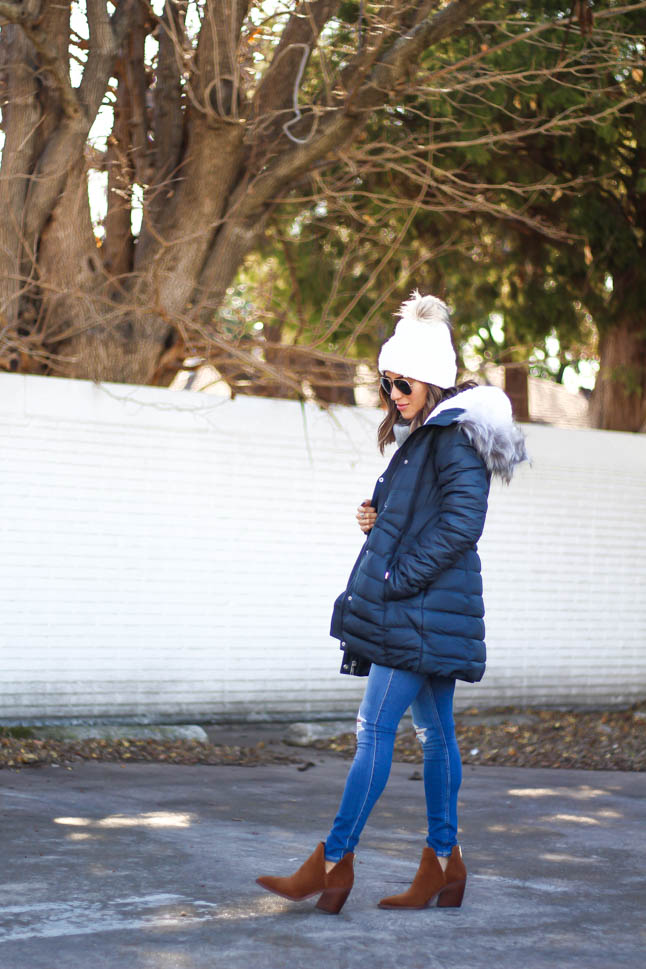 lifestyle and fashion blogger alexis belbel wearing sherpa parka jacket from hollister in black, grey cable turtleneck sweater from hollister, ripped legging jeans from hollister co, brown suede booties from vince camuto, white pom pom cable beanie from hollister | adoubledose.com