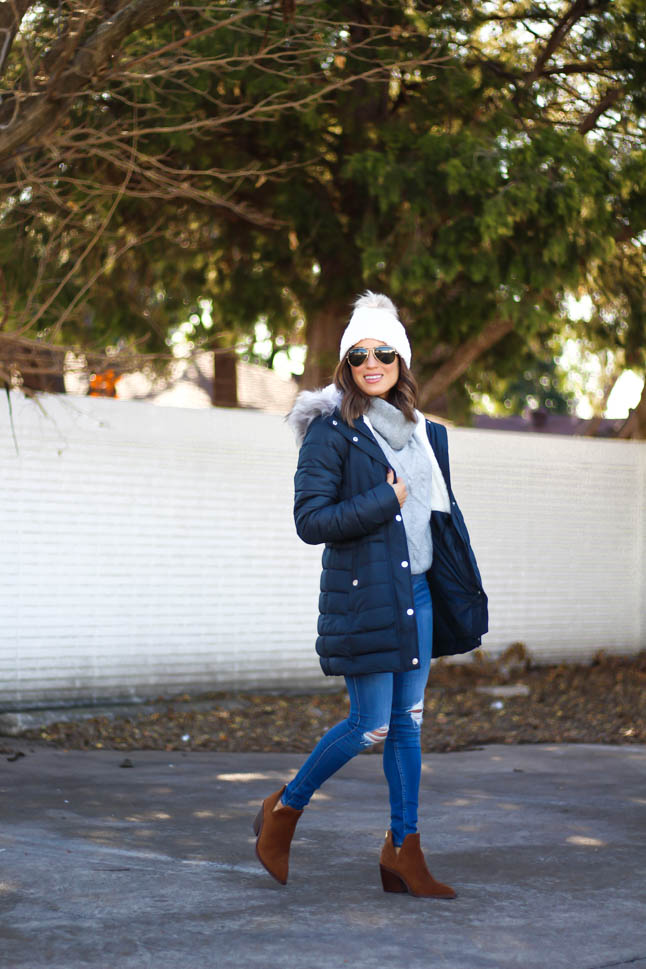 lifestyle and fashion blogger alexis belbel wearing sherpa parka jacket from hollister in black, grey cable turtleneck sweater from hollister, ripped legging jeans from hollister co, brown suede booties from vince camuto, white pom pom cable beanie from hollister | adoubledose.com