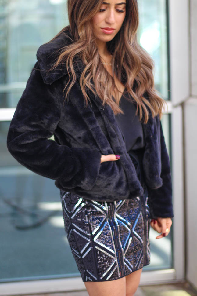 lifestyle and fashion blogger samantha belbel wearing a black and grey sequin mini skirt from express with a black faux fur jacket and black silk cami for new years eve 2019 outfit idea with  | adoubledose.com