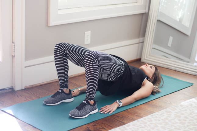 lifestyle and fashion blogger alexis belbel wearing a stripe legging and black workout tank and apl sneakers from Walmart sharing 5 easy at home exercises for a workout in january  | adoubledose.com