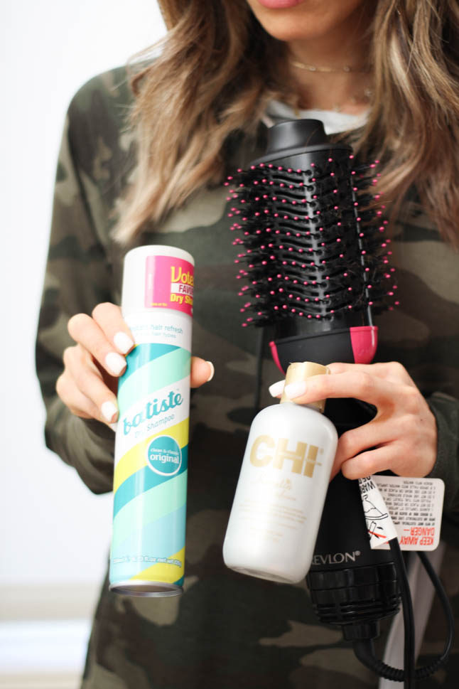 lifestyle and fashion blogger alexis belbel wearing a camo pullover and black leggings sharing her must haves for your gym bag: batiste dry shampoo, revlon hair dryer, mascara, hair ties | adoubledose.com