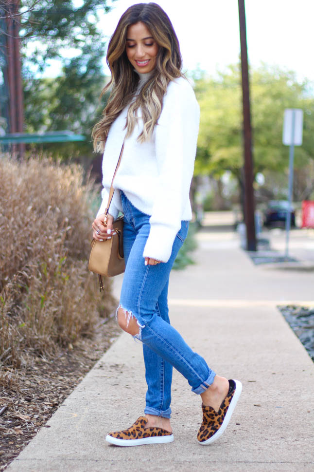 lifestyle and fashion blogger samantha belbel wearing a cozy ivory turtleneck sweater from revolve with levis ripped jeans, leopard sneaker mules from sole society, satchel crossbody bag from sole society, and a neutral scarf | adoubledose.com