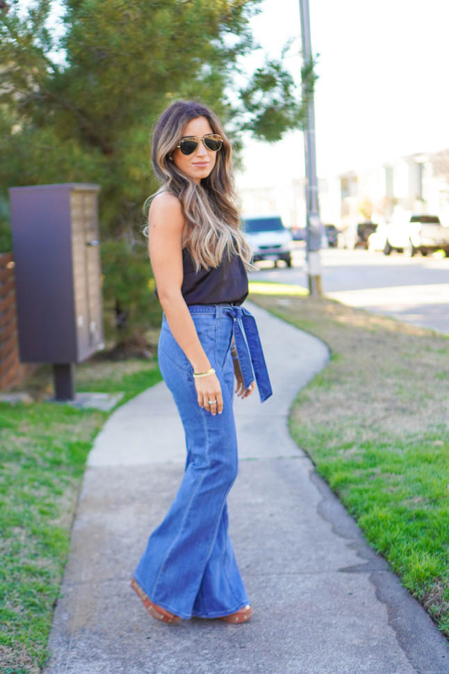 lifestyle and fashion blogger samantha belbel wearing flare jeans and a black lace cami with wedges from Express sharing what is in vs out in fashion spring 2020 trends  | adoubledose.com