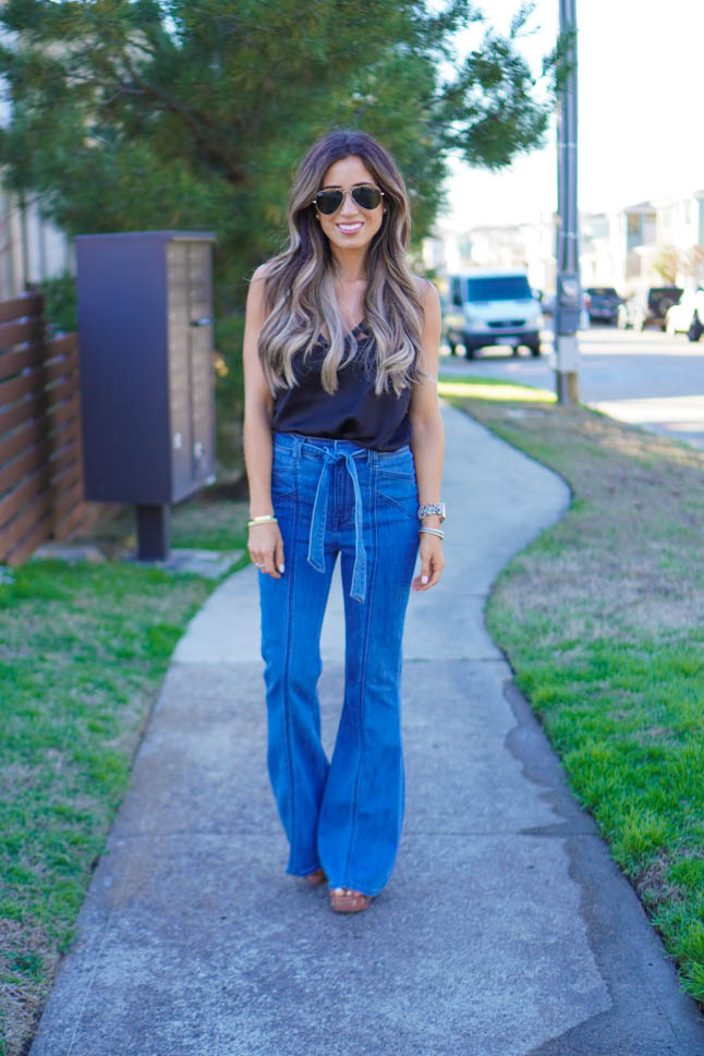 lifestyle and fashion blogger samantha belbel wearing flare jeans and a black lace cami with wedges from Express sharing what is in vs out in fashion spring 2020 trends  | adoubledose.com