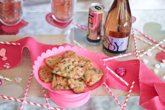 lifestyle and fashion blogger alexis and samantha belbel sharing their tips for hosting the perfect galentine's day with JaM cellars rose wine wearing red heart pajamas and festive valentines day decor| adoubledose.com