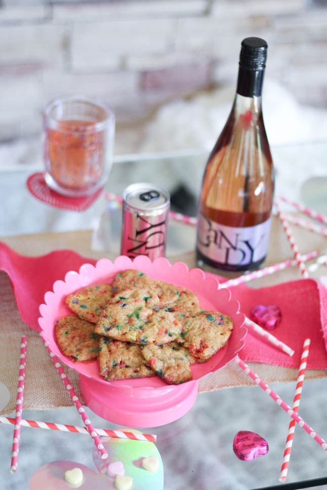 lifestyle and fashion blogger alexis and samantha belbel sharing their tips for hosting the perfect galentine's day with JaM cellars rose wine wearing red heart pajamas and festive valentines day decor| adoubledose.com