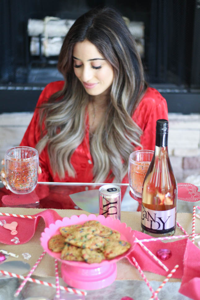 lifestyle and fashion blogger alexis and samantha belbel sharing their tips for hosting the perfect galentine's day with JaM cellars rose wine wearing red heart pajamas and festive valentines day decor| adoubledose.com