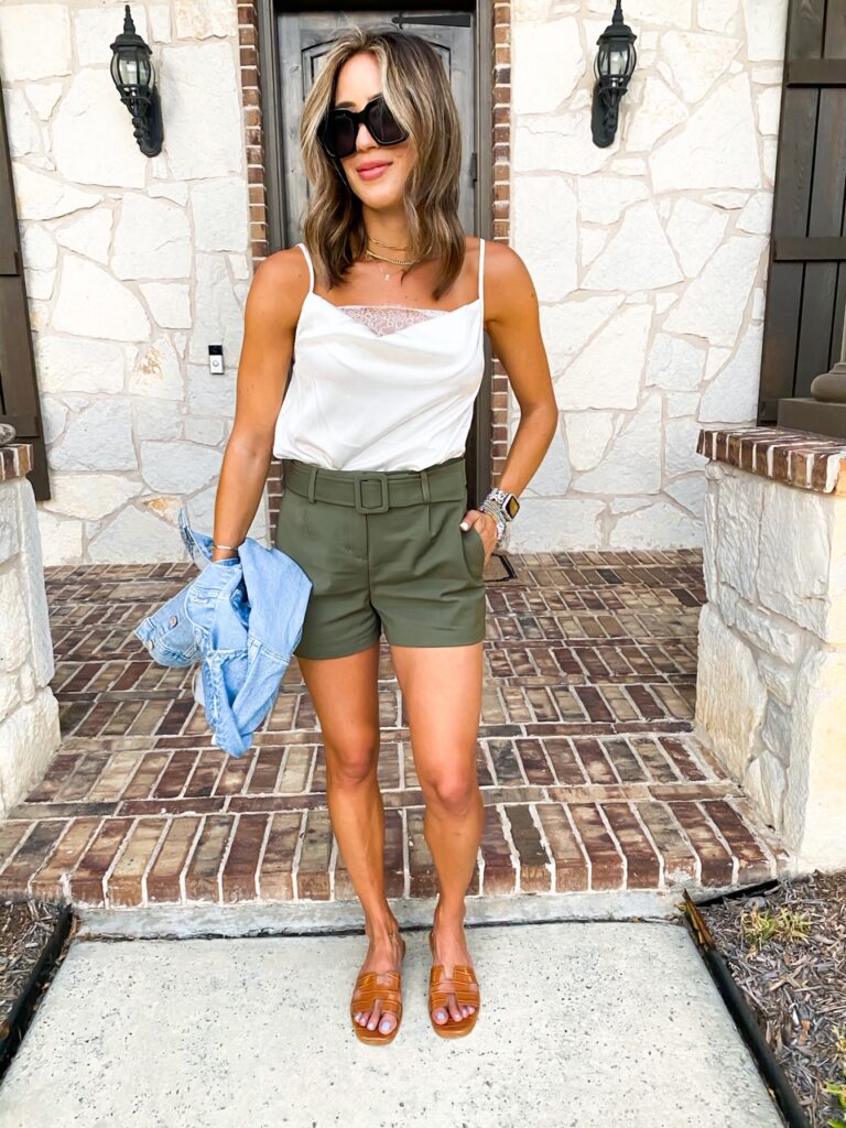 lifestyle and fashion blogger alexis belbel sharing how to style green shorts with a denim jacket and lace bodysuit from express and a white lace top with ripped skinny jeans for petites | adoubledose.com