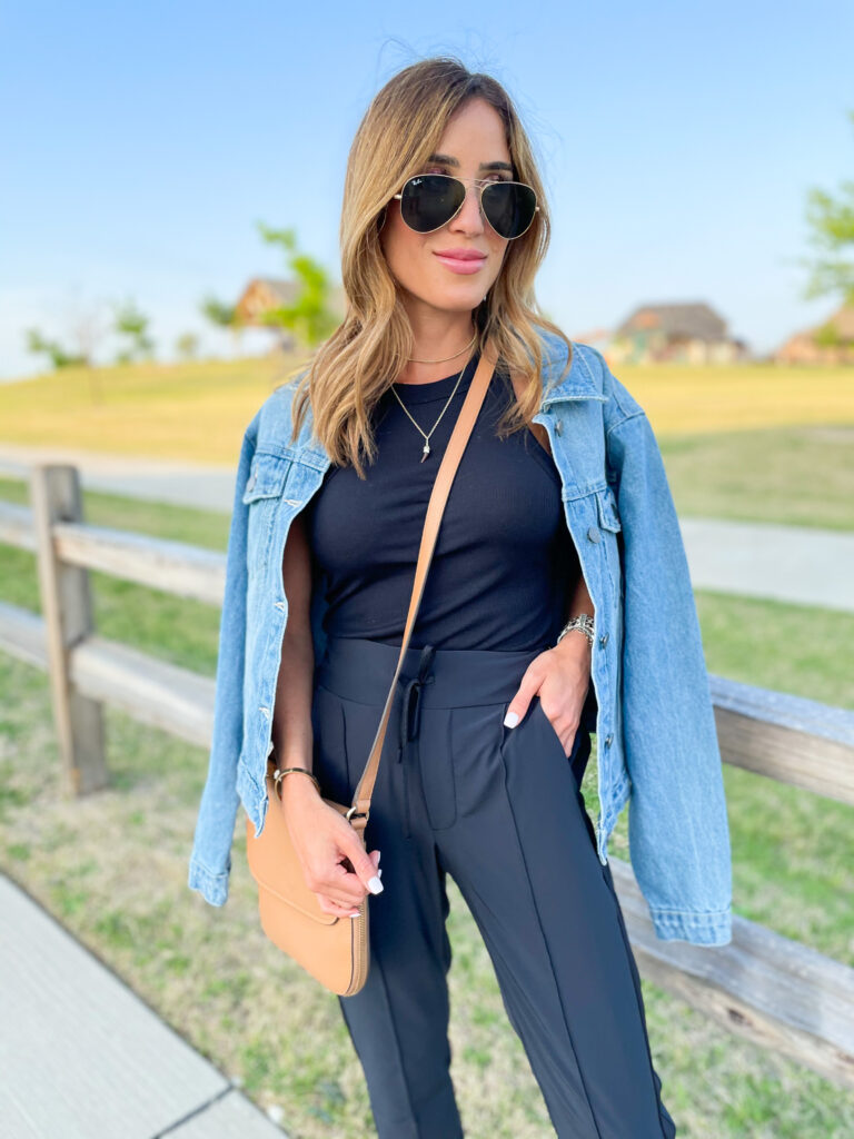 lifestyle and fashion blogger alexis belbel shares a few ways to style woven drawstring joggers from Zella at Nordstrom. Wearing with a black ribbed tank and denim jacket and slide sandals | adoubledose.com