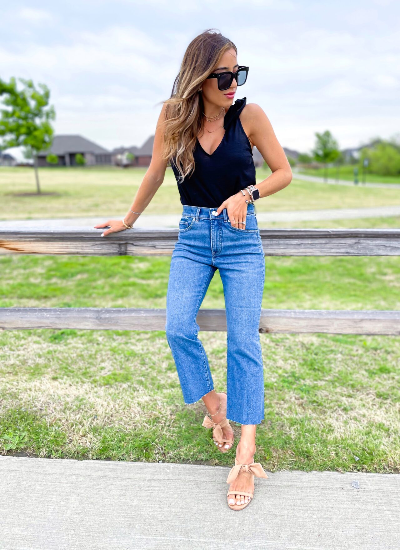 lifestyle and fashion bloggers alexis and samantha belbel share their favorite cropped flare jeans for petites from express and how to style them - with a bodysuit and black tank | adoubledose.com